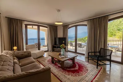 a living room with a couch and a table and a tv at Zorka in Budva