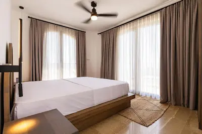 a bedroom with a bed and a ceiling fan at Zorka in Budva