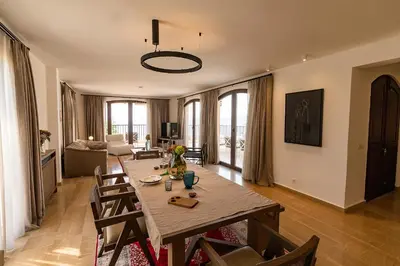 a living room with a wooden table and chairs at Zorka in Budva