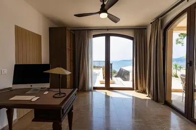 an office with a desk and a large sliding glass door at Zorka in Budva