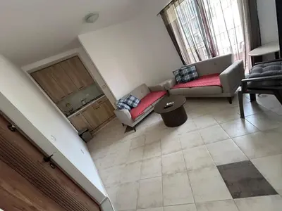 a living room with a couch and a table at Sun & Sea Terrace Apartment in Becici