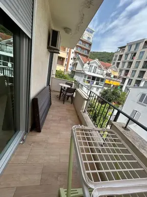 a balcony with a bench and a table on a building at Sun & Sea Terrace Apartment in Becici