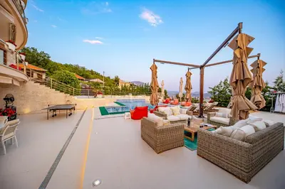 a patio with wicker furniture and a swimming pool at Villa Stella in Bar