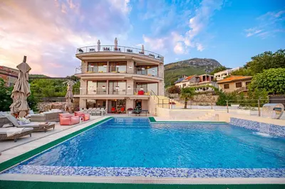 a house with a swimming pool in front of a building at Villa Stella in Bar