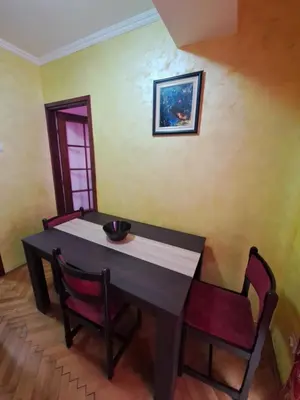 a dining room table with two chairs and a picture on the wall at Sunrise 2 in Podgorica