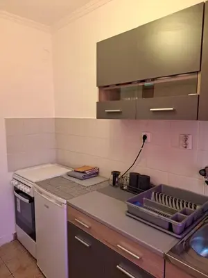a kitchen with a counter with a sink and a stove at Sunrise 2 in Podgorica