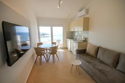 a living room with a couch and a table at Aleksandra Apartments Utjeha in Utjeha