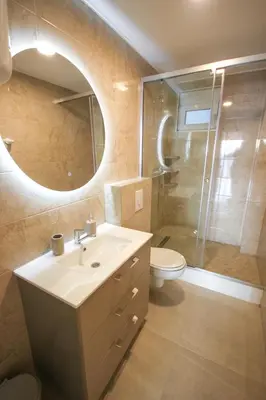 a bathroom with a sink and a toilet and a mirror at Aleksandra Apartments Utjeha in Utjeha