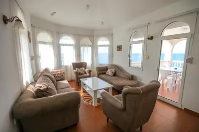 a living room with couches and chairs and a table at Aleksandra Apartments Utjeha in Utjeha