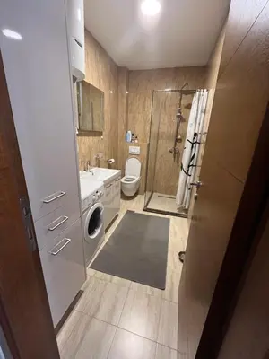 a bathroom with a sink and a washing machine at Natali 1 in Budva