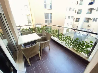 a balcony with a table and chairs on a building at Natali 1 in Budva