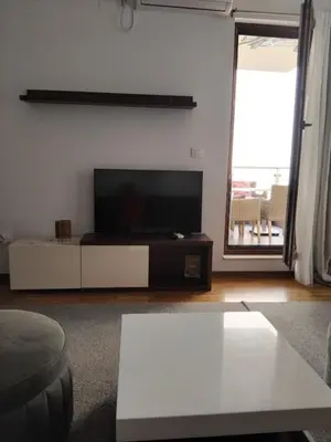 a living room with a flat screen tv on a wall at Natali 1 in Budva