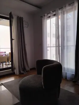 a living room with a chair and a large window at Natali 1 in Budva
