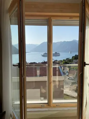 a window with a view of the water at Boka View Apartments in Kotor