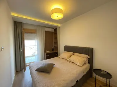 a bedroom with a bed with a light on the ceiling at Boka View Apartments in Kotor