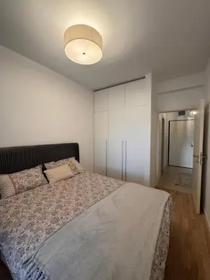 a bedroom with a large bed and a light at Boka View Apartments in Kotor