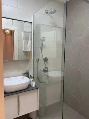 a bathroom with a glass shower and a sink at Boka View Apartments in Kotor