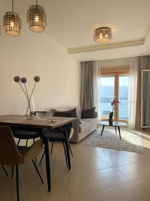 a living room with a table and a couch at Boka View Apartments in Kotor