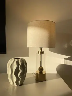 a lamp sitting on a table next to a vase at Boka View Apartments in Kotor