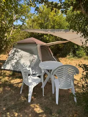 a table and two chairs and a tent at Greenfield campsite in Donji Štoj