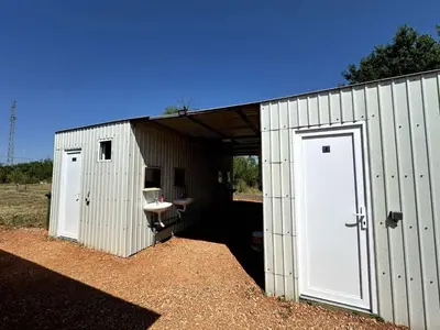 a white shed with a sink and a toilet at Greenfield campsite in Donji Štoj