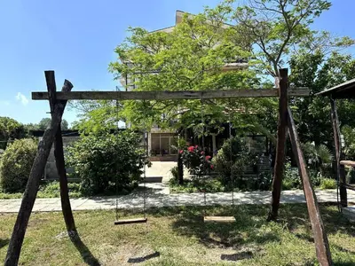 a wooden cross in the yard of a house at Greenfield campsite in Donji Štoj