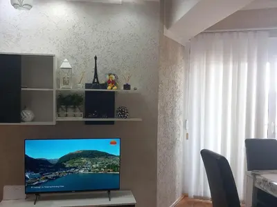 a living room with a flat screen tv on a wall at APARTMENTS ANI Ester in Ulcinj