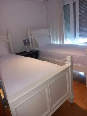 two white beds in a room with a window at APARTMENTS ANI Ester in Ulcinj