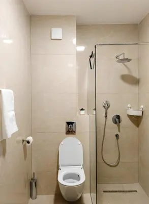 a bathroom with a shower with a toilet and a glass door at Modern City Apartment Budva-Central Location,5 min to Beach in Budva