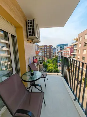 a balcony with a table and chairs and a view at Modern City Apartment Budva-Central Location,5 min to Beach in Budva