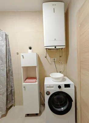 a kitchen with a washing machine and a cabinet at Modern City Apartment Budva-Central Location,5 min to Beach in Budva