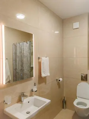 a bathroom with a sink and a toilet and a mirror at Modern City Apartment Budva-Central Location,5 min to Beach in Budva