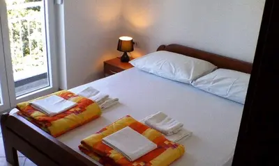 a bedroom with a bed with two towels on it at Wonderful Seaview Apartment in Ulcinj