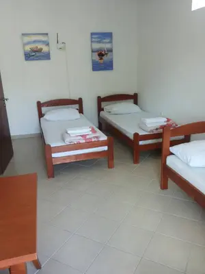 a room with three beds in a room at Wonderful Seaview Apartment in Ulcinj