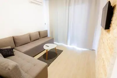 a living room with a couch and a table at LAReina- Best Buy in Ulcinj