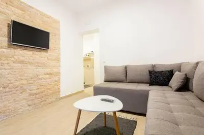 a living room with a couch and a table at LAReina- Best Buy in Ulcinj