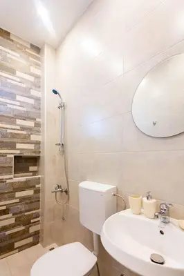 a bathroom with a toilet and a sink and a mirror at LAReina- Best Buy in Ulcinj