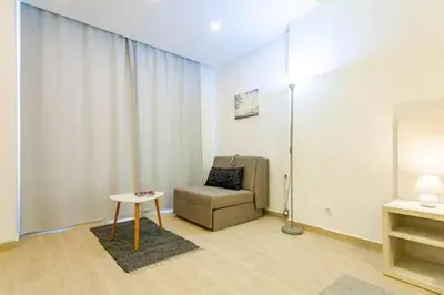 a living room with a chair and a table at LAReina- Best Buy in Ulcinj