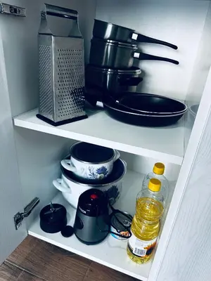 a cupboard filled with lots of kitchen utensils at Apartment Comfort A15 in Bar