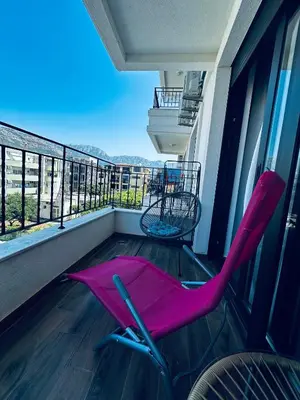 a pink chair sitting on a balcony with a view at Apartment Comfort A15 in Bar