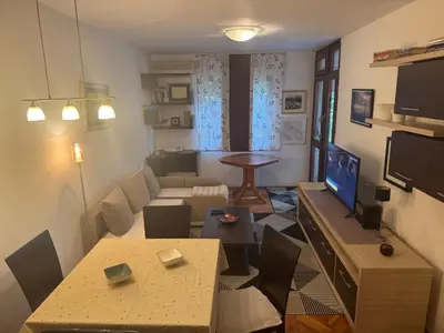 a small living room with a couch and a table at Modern Apartment Free Parking Near Center in Podgorica