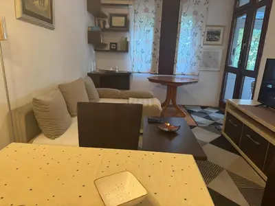 a living room with a couch and a table at Modern Apartment Free Parking Near Center in Podgorica