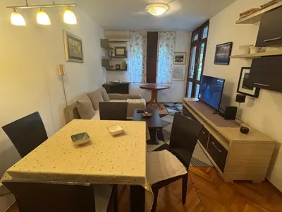 a small living room with a table and a living room at Modern Apartment Free Parking Near Center in Podgorica