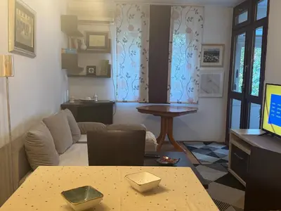 a living room with a couch and a table at Modern Apartment Free Parking Near Center in Podgorica