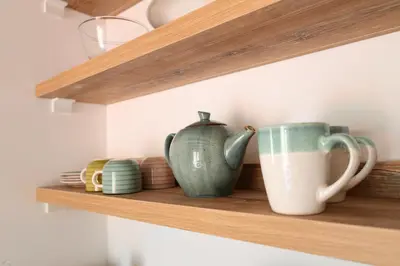 a shelf with two cups and bowls on it at Kotor Lovers in Kotor