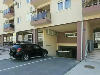 a black car parked in front of a building at Studio Maris in Budva