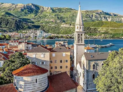 a church with a steeple on top of a city at Studio Maris in Budva