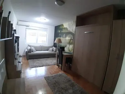a living room with a couch and a table at Studio Maris in Budva