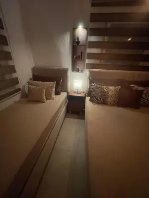 a small room with a bed and a staircase at Lux Apartman David Dobra voda in Bar