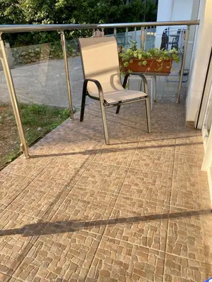 a chair sitting on a brick patio with a table at Wonder home in Sutomore